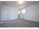 Neutral bedroom featuring carpet and access to bathroom, with windows for natural light at 6355 Valhalla Dr, Douglasville, GA 30135