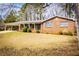 Front view of a red brick home with a covered front porch and driveway at 6355 Valhalla Dr, Douglasville, GA 30135