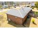 An aerial view of the brick home showing the roof and surrounding yard at 6355 Valhalla Dr, Douglasville, GA 30135