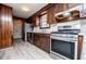 Galley kitchen featuring stainless steel appliances, wood cabinetry, and an open layout at 6355 Valhalla Dr, Douglasville, GA 30135
