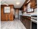 Galley kitchen featuring stainless steel appliances, wood cabinetry, and wood paneling at 6355 Valhalla Dr, Douglasville, GA 30135