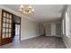 Open living room with wood-look floors, crown molding, and decorative french doors at 6355 Valhalla Dr, Douglasville, GA 30135