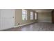 Bright, empty living room with light wood flooring and large windows at 6355 Valhalla Dr, Douglasville, GA 30135