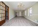 Bright, open floor plan with hardwood floors, large windows, and crown molding details at 6355 Valhalla Dr, Douglasville, GA 30135