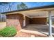 A covered patio area with brick columns, brick pavers and access to the backyard at 6355 Valhalla Dr, Douglasville, GA 30135