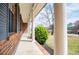 Covered porch with classic white columns and brick accents at 6355 Valhalla Dr, Douglasville, GA 30135