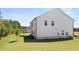 Back of house with green lawn and trees at 640 Kimberwick Dr, Locust Grove, GA 30248
