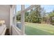 Backyard view from a light-filled room with a window, showcasing the expansive, green lawn and trees at 640 Kimberwick Dr, Locust Grove, GA 30248