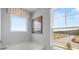 Bright bathroom with a soaking tub and large window overlooking a pastoral landscape at 640 Kimberwick Dr, Locust Grove, GA 30248