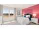Bright bedroom with a pink accent wall and large window offering plenty of natural light at 640 Kimberwick Dr, Locust Grove, GA 30248