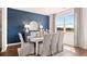 Dining room with a large window and a white dining set with blue accent wall at 640 Kimberwick Dr, Locust Grove, GA 30248
