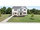 Charming two-story home boasts a lush lawn and a classic white brick and vinyl facade at 640 Kimberwick Dr, Locust Grove, GA 30248
