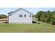 View of the rear of the white two-story house showcasing the backyard and the siding at 640 Kimberwick Dr, Locust Grove, GA 30248