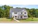 Classic two-story home boasts a lush green lawn and a white brick and vinyl facade at 640 Kimberwick Dr, Locust Grove, GA 30248