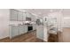 Spacious kitchen with stainless appliances, granite countertops, grey cabinets, and hardwood floors at 640 Kimberwick Dr, Locust Grove, GA 30248