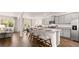Open kitchen features granite countertops, stainless appliances, an island, and an adjacent dining area at 640 Kimberwick Dr, Locust Grove, GA 30248