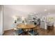 Open-concept kitchen and dining area featuring gray cabinets, stainless steel appliances, and a cozy breakfast bar at 640 Kimberwick Dr, Locust Grove, GA 30248