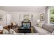 Open-concept living room with a comfortable sofa, accent chairs, and decorative elements at 640 Kimberwick Dr, Locust Grove, GA 30248