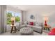Comfortable living area with a sectional sofa, decorative pillows, and ample natural light from a nearby window at 640 Kimberwick Dr, Locust Grove, GA 30248