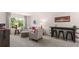 Relaxing living area featuring modern furniture, sporty decor, and a versatile space for entertainment and relaxation at 640 Kimberwick Dr, Locust Grove, GA 30248