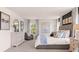 Bright main bedroom featuring a large bed, dresser, accent wall, and natural light from the large window at 640 Kimberwick Dr, Locust Grove, GA 30248