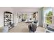 Bright, carpeted main bedroom with a large bed and sitting area bathed in natural light at 640 Kimberwick Dr, Locust Grove, GA 30248