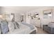 Bright and cozy bedroom featuring a large bed, a dresser, and stylish decor at 640 Kimberwick Dr, Locust Grove, GA 30248