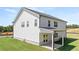 Back exterior of a white two-story house featuring a covered patio and a large yard at 640 Kimberwick Dr, Locust Grove, GA 30248