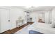 Well-lit bedroom with stylish decor, wooden floors, and barn door leading to the bathroom at 693 Fielding Sw Ln, Atlanta, GA 30311