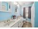Bright bathroom featuring a double sink vanity, tile floors and a shower/tub combo at 9975 Holly Hill Way, Jonesboro, GA 30238