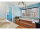 Bright bathroom featuring double sinks and a sunken tub with beautiful views at 9975 Holly Hill Way, Jonesboro, GA 30238