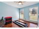Cozy bedroom with two windows offering natural light and beautiful hardwood floors throughout at 9975 Holly Hill Way, Jonesboro, GA 30238