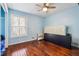 Cozy bedroom featuring natural light and beautiful hardwood floors throughout at 9975 Holly Hill Way, Jonesboro, GA 30238