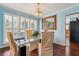 Bright dining area featuring a glass-top table, chandelier, and large window at 9975 Holly Hill Way, Jonesboro, GA 30238