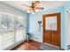 Inviting entryway features wood-look floors, a convenient coat rack, and a glimpse into the garage at 9975 Holly Hill Way, Jonesboro, GA 30238