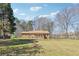 Spacious home with a large front yard, mature trees, and a classic brick facade at 9975 Holly Hill Way, Jonesboro, GA 30238