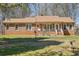 Charming single-story brick home featuring a cozy front porch and well-maintained lawn at 9975 Holly Hill Way, Jonesboro, GA 30238