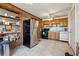Functional kitchen with stainless steel refrigerator, wooden cabinets, and tile flooring at 9975 Holly Hill Way, Jonesboro, GA 30238