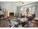 Comfortable living room with hardwood floors, a cozy fireplace, and plenty of natural light at 2099 Winsburg Nw Way, Kennesaw, GA 30144