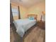 Cozy bedroom featuring wood laminate floors, complemented by a comfortable bed and natural lighting at 2958 Klondike Rd, Lithonia, GA 30038