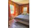 Bedroom features wood paneled walls and bright orange curtains at 2958 Klondike Rd, Lithonia, GA 30038