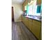 Bright kitchen with gray floors, olive green cabinets, a black countertop, and a window at 2958 Klondike Rd, Lithonia, GA 30038