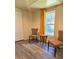Cozy room featuring two patterned chairs, a small table, a window, and a white door at 2958 Klondike Rd, Lithonia, GA 30038