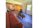 Spacious living room with gray floors, comfortable seating, a coffee table, and a dining area in background at 2958 Klondike Rd, Lithonia, GA 30038