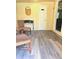 Inviting seating area with gray floors, patterned seating, a table, a mirror, and a white door at 2958 Klondike Rd, Lithonia, GA 30038