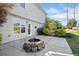 Concrete patio with fire pit and pergola, surrounded by well-maintained landscaping and a grassy area at 3313 Summit Creek Ln, Loganville, GA 30052