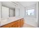 Double sink vanity and separate soaking tub, plus large mirror in the primary bath at 3313 Summit Creek Ln, Loganville, GA 30052