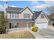 Charming two-story home with a manicured lawn, two-car garage, and inviting front porch at 3313 Summit Creek Ln, Loganville, GA 30052