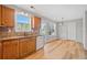 Functional kitchen featuring granite countertops, wooden cabinetry, and white appliances at 3313 Summit Creek Ln, Loganville, GA 30052