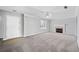 Open living room with fireplace, neutral walls and carpet, with door to front at 3313 Summit Creek Ln, Loganville, GA 30052